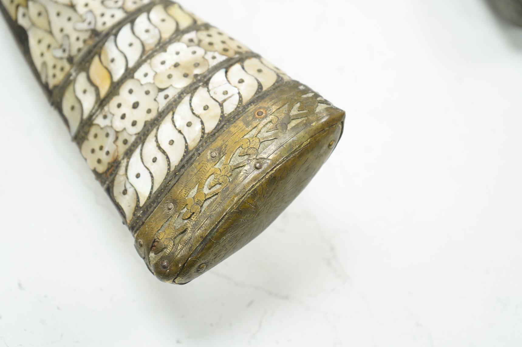 A Balkan miquelet flintlock gun with part octagonal Damascus twist barrel, silver inlaid at breach and muzzle, brass covered stock with shaped mother-of-pearl segments covering the butt, the side of stock inscribed ‘Piet